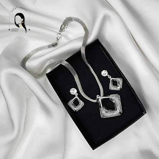 A Silver Modren Necklace and Earrings with White Crystals